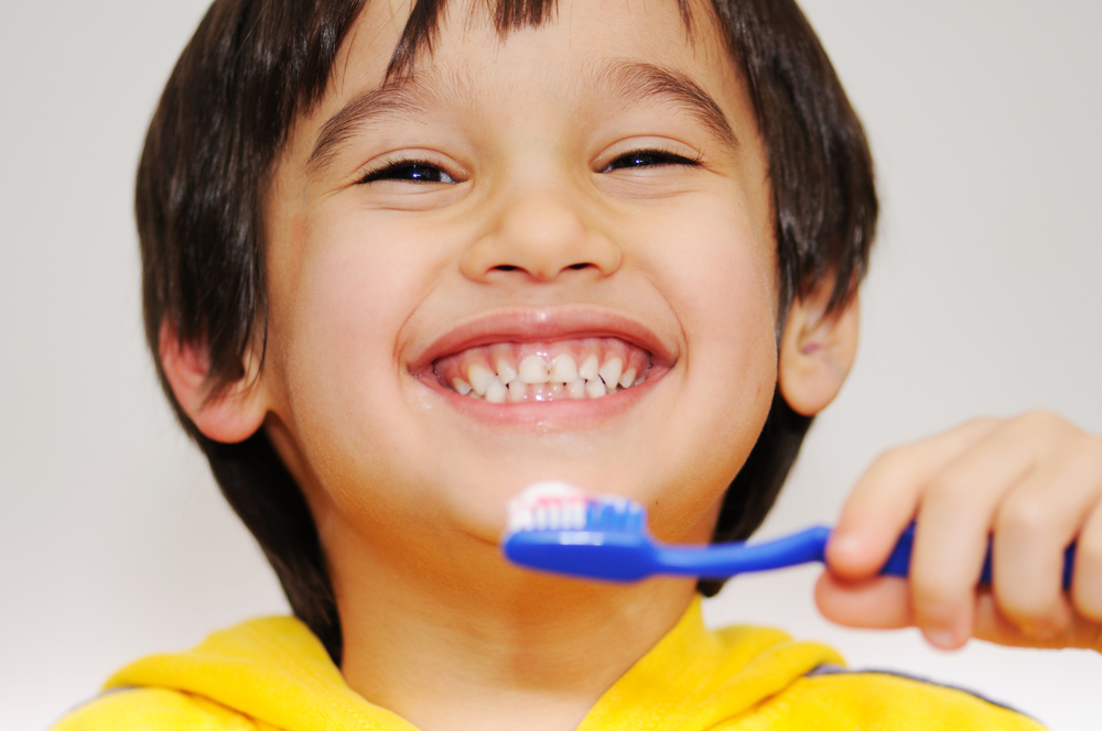 Happy-Child-Brushing-Teeth-At-Home