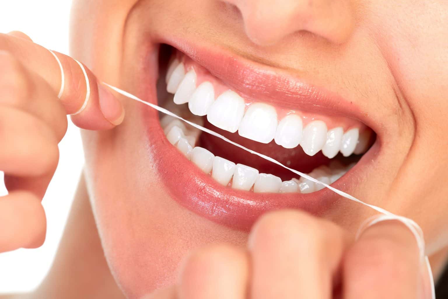 Lady smiling and flossing